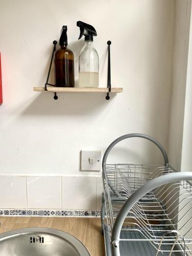 a kitchen with a dish rack and a shelf at Seaview Richmond Terrace in Swansea