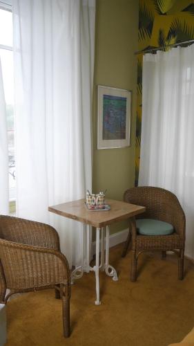 a table and two chairs in a room at Maison Castel Braz in Pont-Aven