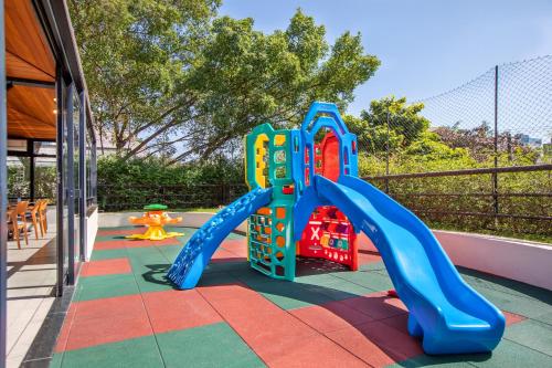 a playground with a slide on a patio at São Paulo Tatuape, Affiliated by Meliá in Sao Paulo