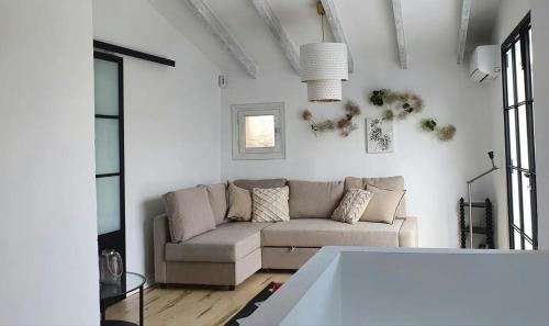 a white living room with a couch and a table at Casa DeLaLuz in Altea