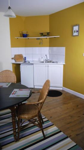 a kitchen with a table and chairs and a sink at Maison Castel Braz in Pont-Aven