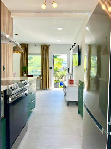 a kitchen with green and white counters and a stove at 3 Seasons at the Carrington 3 Two Bedroom 1 Bath Apts -6 Bedrooms 3 bathrooms and 3 bedroom 2 bathroom Villa in Miami