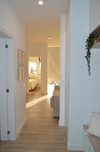 a hallway leading to a bedroom with a bed at Rosamar 211 Los Cristianos Ocean Views in Arona