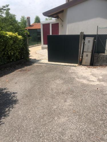 a driveway in front of a house with a garage at Ragaraja private suite & SPA in Pordenone