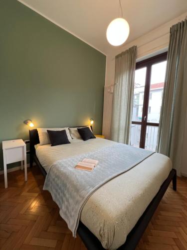 sypialnia z dużym łóżkiem i dużym oknem w obiekcie Premium high floor design apartment in Città Studi w Mediolanie