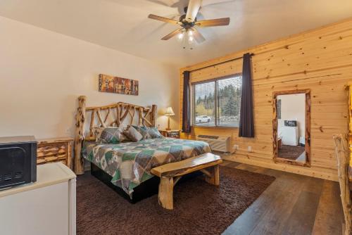 a bedroom with a bed and a ceiling fan at Gateway Inn in Grand Lake