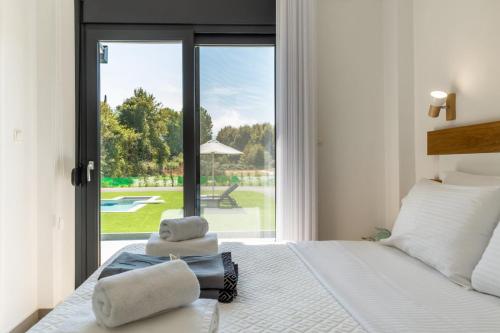 a bedroom with a bed with towels on it at Lobster in Leptokaria