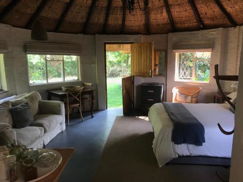 a bedroom with a bed and a living room at Gartmore Guest Farm in Howick