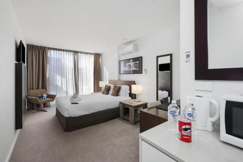 a hotel room with a bed and a television at Resort Two Bedroom 275 in Torquay
