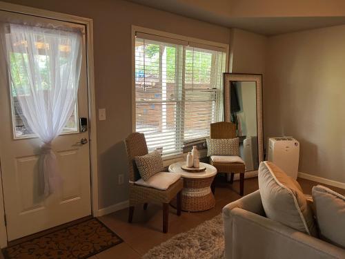 a living room with a door and a table and chairs at E Atlanta 10mins to downtown 15 mins to airport Spacious Apartment in Atlanta