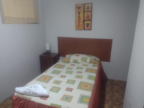 a bedroom with a bed with a bedspread on it at Casa de Isabel in Arequipa