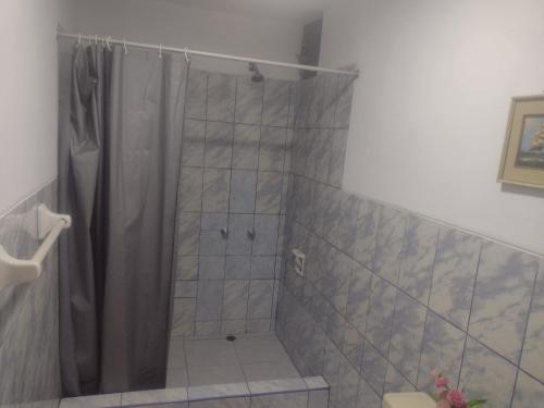a bathroom with a shower with a shower curtain at Casa de Isabel in Arequipa