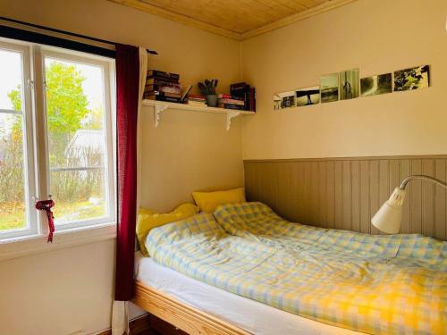 a bedroom with a bed and a window at Holiday home Koppom in Koppom