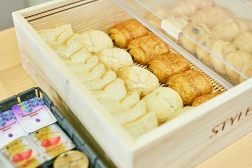 a wooden box filled with different types of pastries at KAMENOI HOTEL Fukui in Fukui
