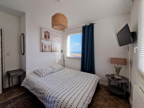 a bedroom with a bed and a television in it at Holiday home in Perros Guirec in Perros-Guirec