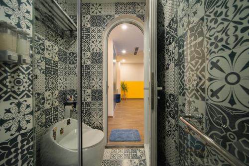 a bathroom with a tub and a walk in shower at Pavillon Garden Hotel in Nha Trang