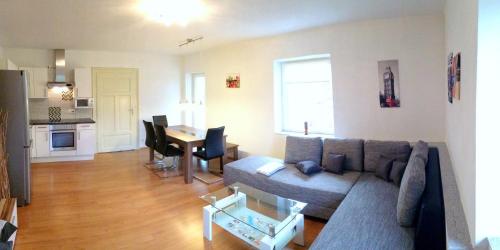 a living room with a couch and a table at Ferienwohnung Haus Maier in Seeboden