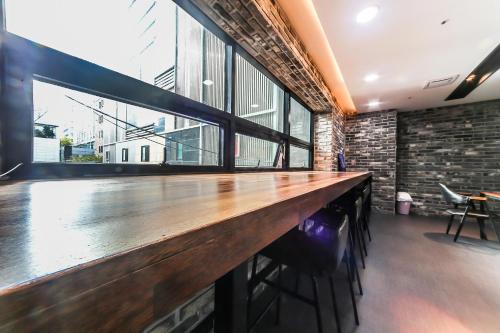 a bar in a room with a large window at Seomyeon Brown-dot hotel Gold in Busan