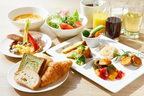 a table with plates of food and bowls of food at Hotel Intergate Kanazawa in Kanazawa