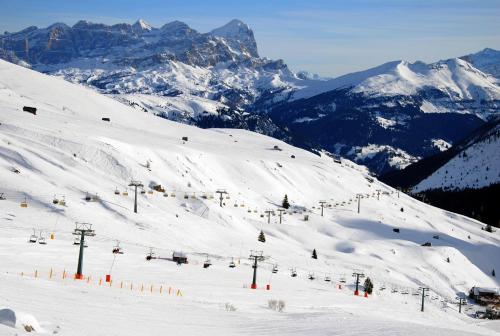 a snow covered ski slope with a ski lift at Dolasilla Park Hotel in Vigo di Fassa