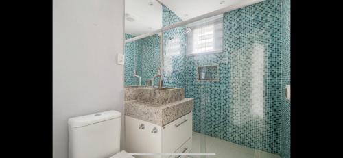 a bathroom with a sink and a toilet at Lindo flat no Guarujá in Guarujá