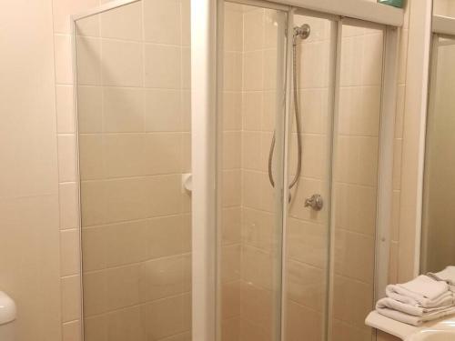 a shower with a glass door in a bathroom at Tingalpa Townhouse Treat in Brisbane