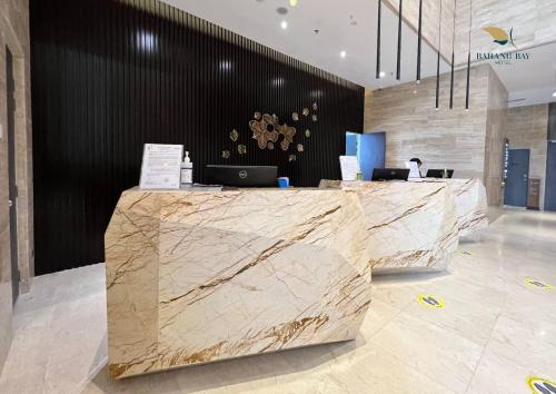 a lobby with a marble counter in a building at Bahang Bay Hotel in Batu Ferringhi