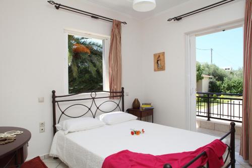 a bedroom with a bed and a large window at Arodo in Lefkada