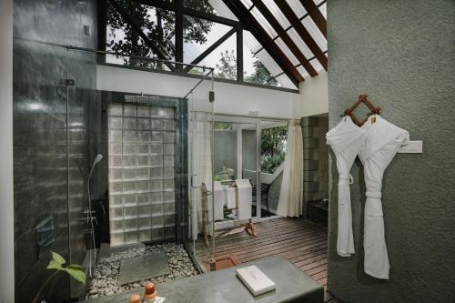 a bathroom with a shower and a glass shower stall at SpiceTree Rajakumari in Munnar