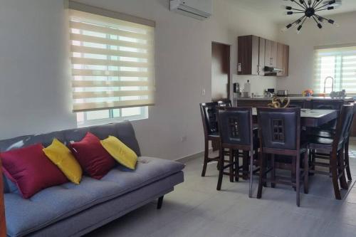 a living room with a couch and a kitchen at Casa Mauricio in La Paz