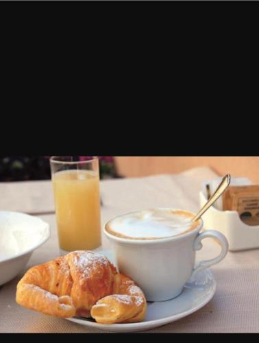 a cup of coffee and a pastry on a table at La casa di Teresa in Taranto