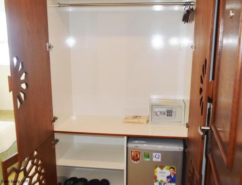 a refrigerator in a kitchen with a counter at Pavillon Garden Hotel in Nha Trang