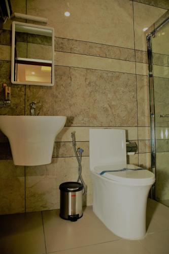 a bathroom with a toilet and a sink at AGS Residency in Ernakulam