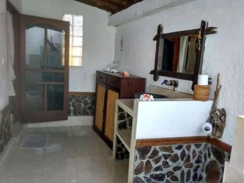 a bathroom with a sink and a mirror at Gili Hideaway in Gili Trawangan