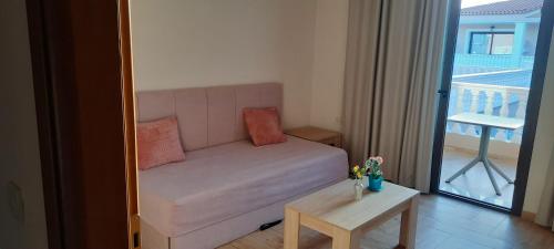 a living room with a couch and a table at Zante Holidays Hotel in Kalamaki