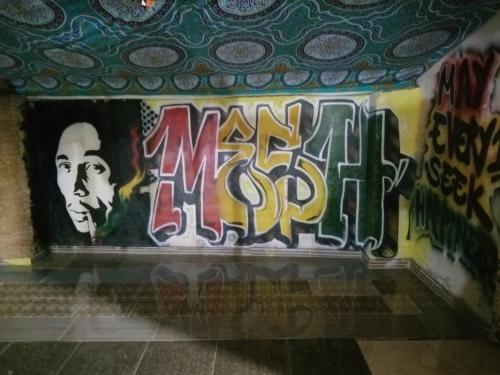 a wall with graffiti on the side of a building at Bob Marley Hotel Luxor in Luxor