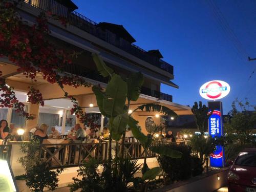 a restaurant with people sitting at tables at night at Piccadilly in Alykes