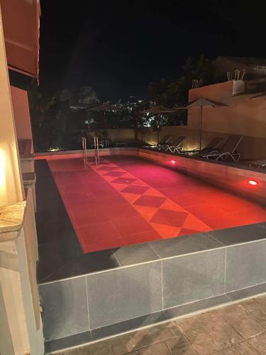 a red carpet on a balcony at night at Piccadilly in Alykes