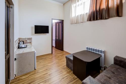 a living room with a couch and a table at H Resort Hotel Vagharshapat Armenia in Vagharshapat