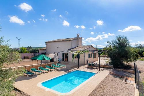 an image of a swimming pool in front of a house at Sa Torreta in Algaida