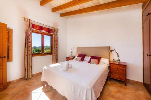 アルガイダにあるSa Torretaのベッドルーム(大きな白いベッド1台、窓付)