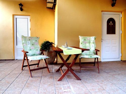 a table and two chairs in a room at Heliofili in Finikounta