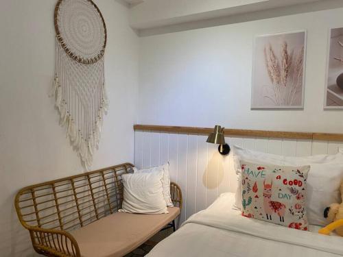 a bedroom with a bed and a chair next to it at Camaya at tanglin apartement in Lontar