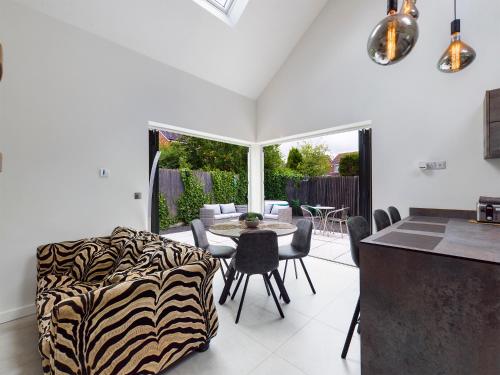 a kitchen and dining room with a table and chairs at Contemporary 2 bedroom eco home with a twist in Marton