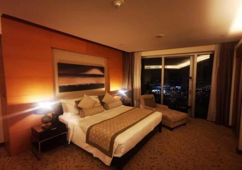 a hotel room with a large bed and a window at Deluxe Studio Address Dubai Mall "The Residence" in Dubai