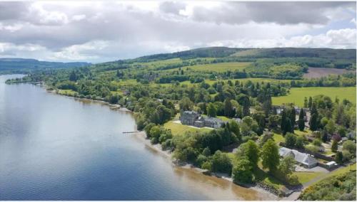 an aerial view of a large lake with trees and houses at Lomond Castle Penthouse in Luss