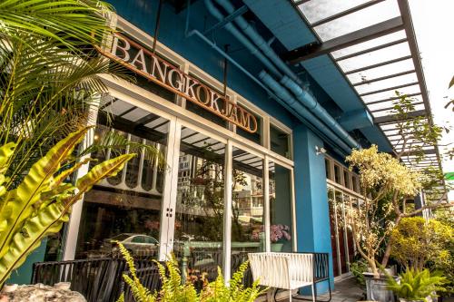 a restaurant with blue walls and plants in front of it at Anna King Hotel in Chiayi City