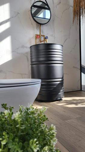 a bathroom with a black tub and a mirror at Executive Junior Suite in Hersonissos
