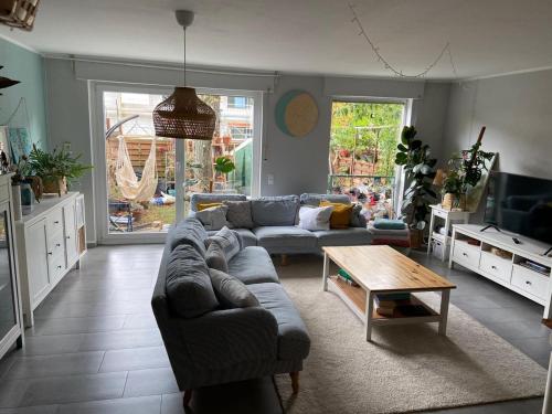 a living room with a couch and a coffee table at stylische Maisonettewohnung Stadionnähe,Wald,Westfalenhalle in Dortmund