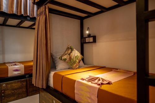 a small room with two beds in it at The Moon Hostel in Batununggul
